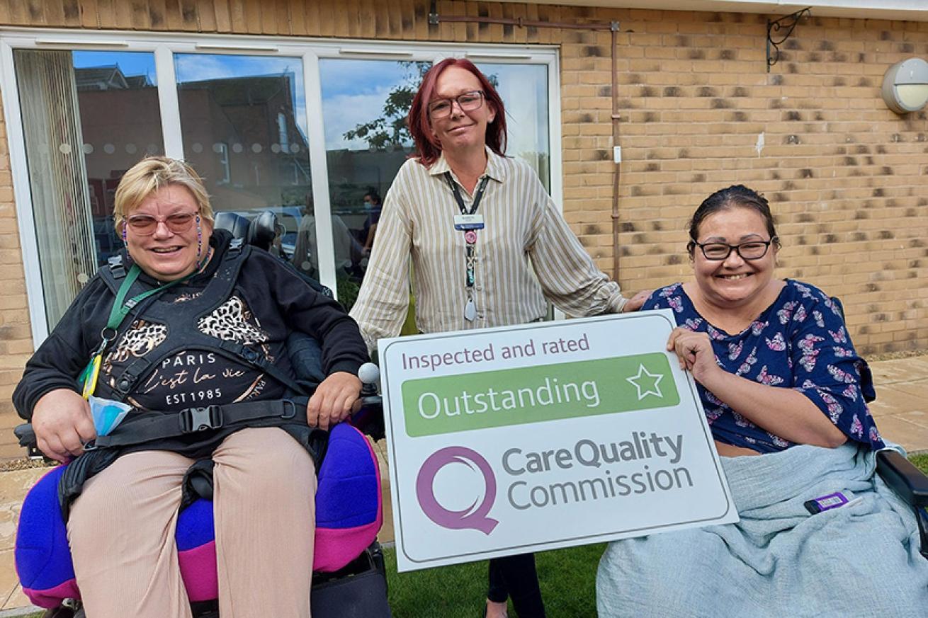 Staff and residents celebrating outstanding CQC rating at service