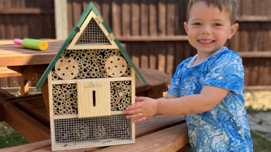 Resident of Ruth House, proudly smiling with his bug house