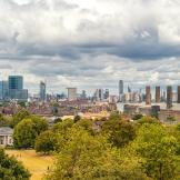 Panoramic views of Greenwich Park and National Maritime Museum, Gardens, University of Greenwich, Old Royal Naval College, River Thames, and the city of London.
