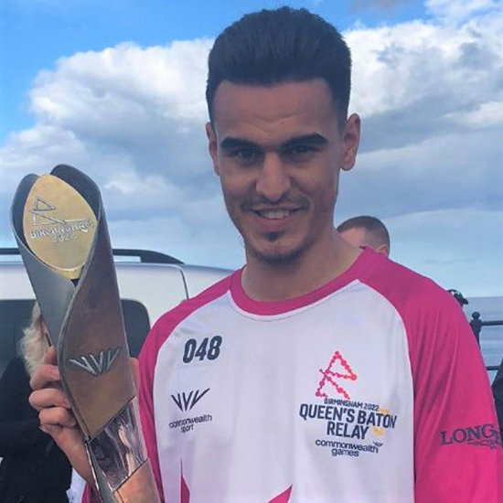 Adam Jaffri holding the Queen's baton