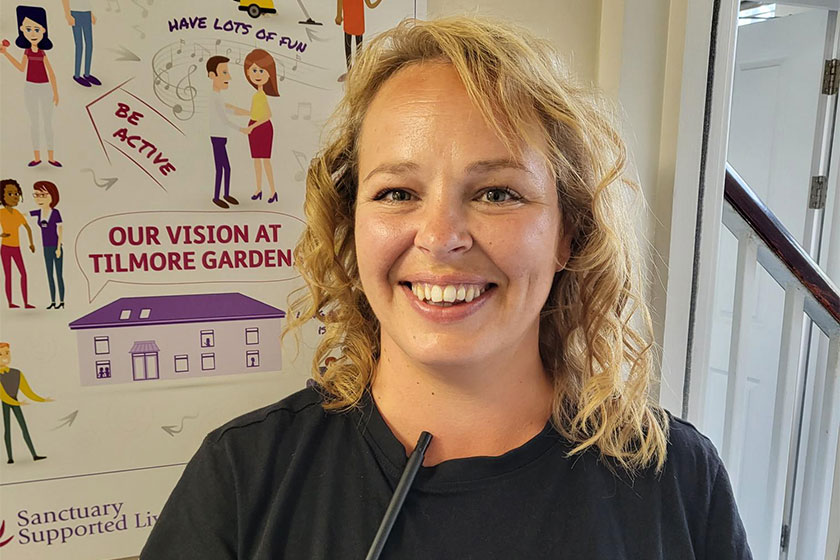 Care and Support Assistant at Tilmore Gardens, smiling at the camera 