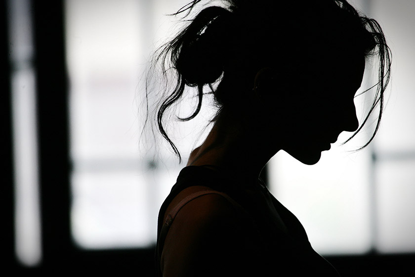 Silhouette of a woman with her hair tied up