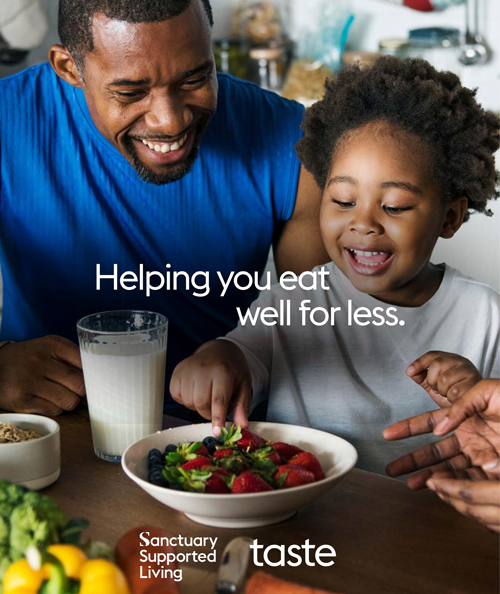 A father and sun smiling with a bowl of fruit and a glass of milk