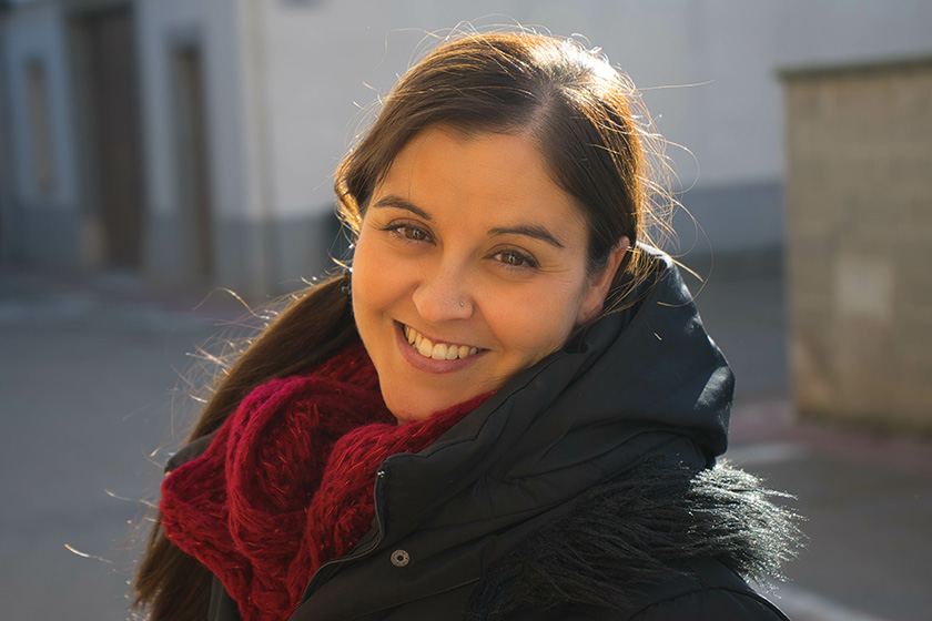 A lady looking into the camera smiling