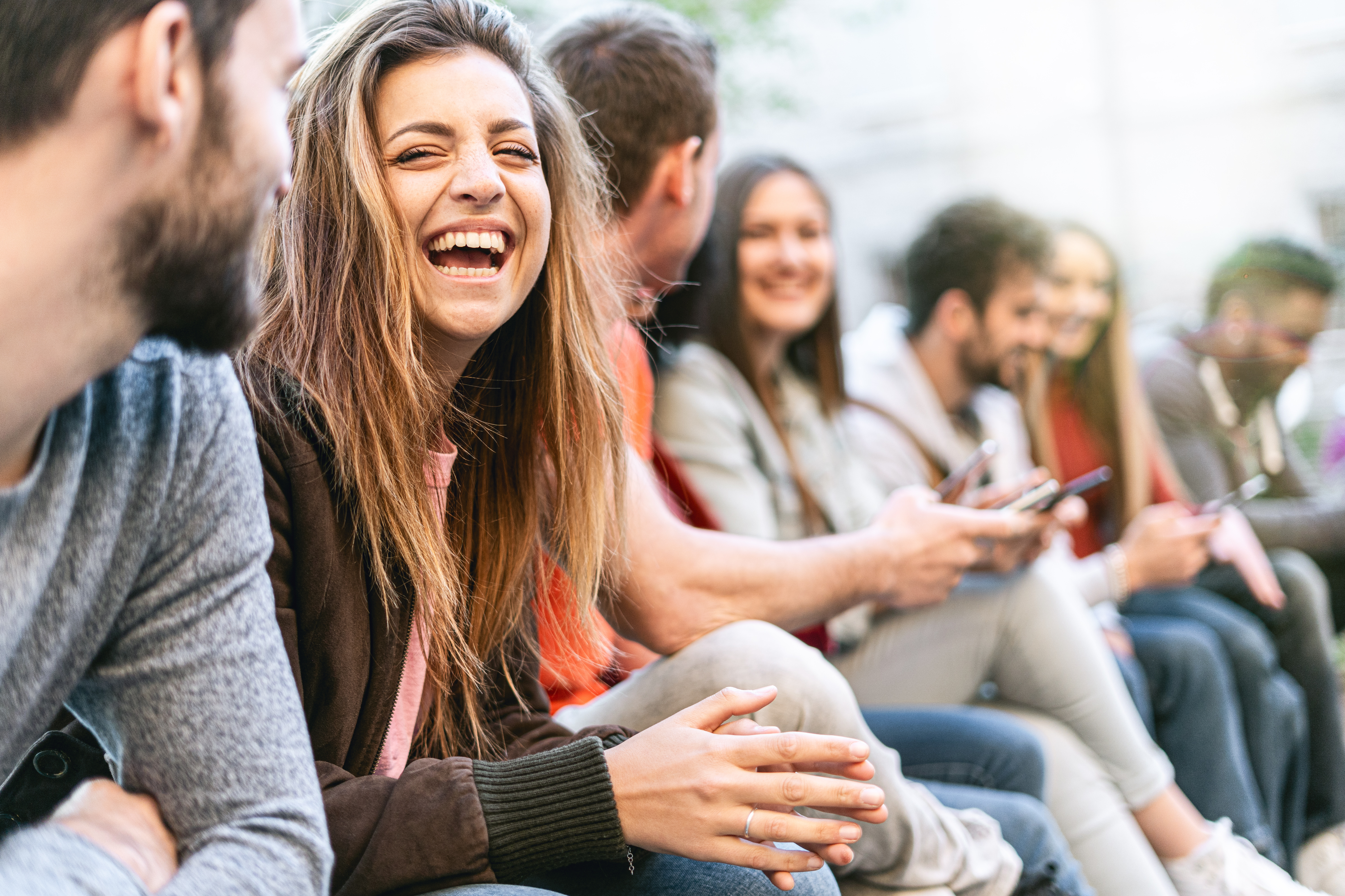 A group of young people smiling and chatting