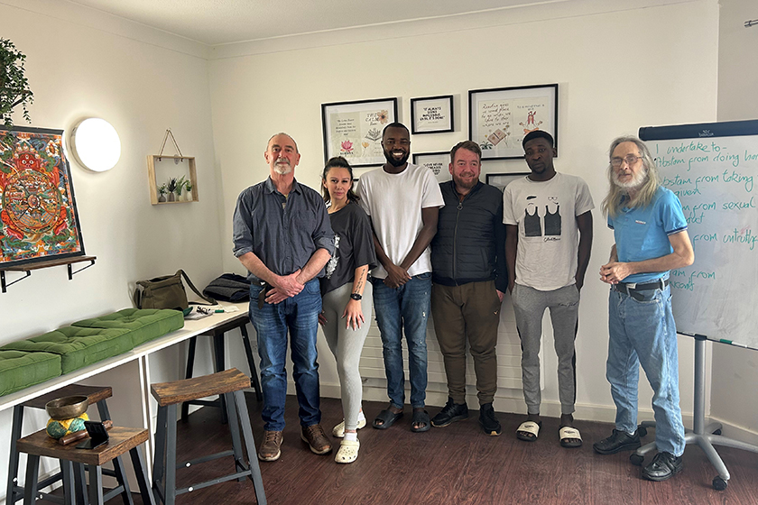 Residents and staff at Queen Elizabeth Way celebrate the opening of their new wellbeing room with a guest speaker from the Colchester Buddhist Centre.