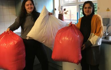 Residents hold the bags of donated pillows
