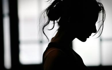 Silhouette of a woman with her hair tied up