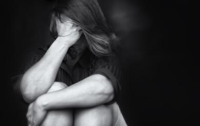 Stock image of a woman covering her face with her hands