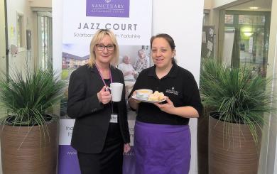 Hannah Sykes and Liz Jones holding tea and cakes at Jazz Court