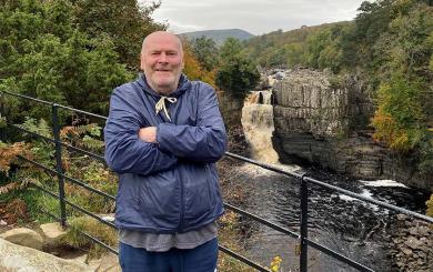 Station Road resident Gary standing in front of a waterfall