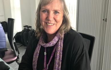 Training and Quality Officer, Sharron Gresty smiling at her desk