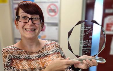 Heather Davies holding her award from the Great British Care Awards