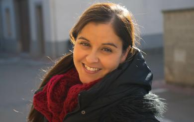 A lady looking into the camera smiling