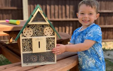 Resident of Ruth House, Ronnie proudly smiling with his bug house