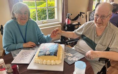 A couple who have been married for 60 years sat together in their retirement home and smiling