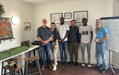 Residents and staff at Queen Elizabeth Way celebrate the opening of their new wellbeing room with a guest speaker from the Colchester Buddhist Centre.