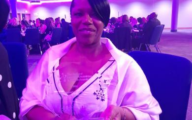 Lynn Clarke holding her award at the National Learning Disabilities and Autism Awards event