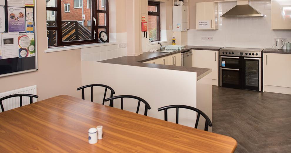 Cosy wooden dining area with an open plan view into the kitchen.