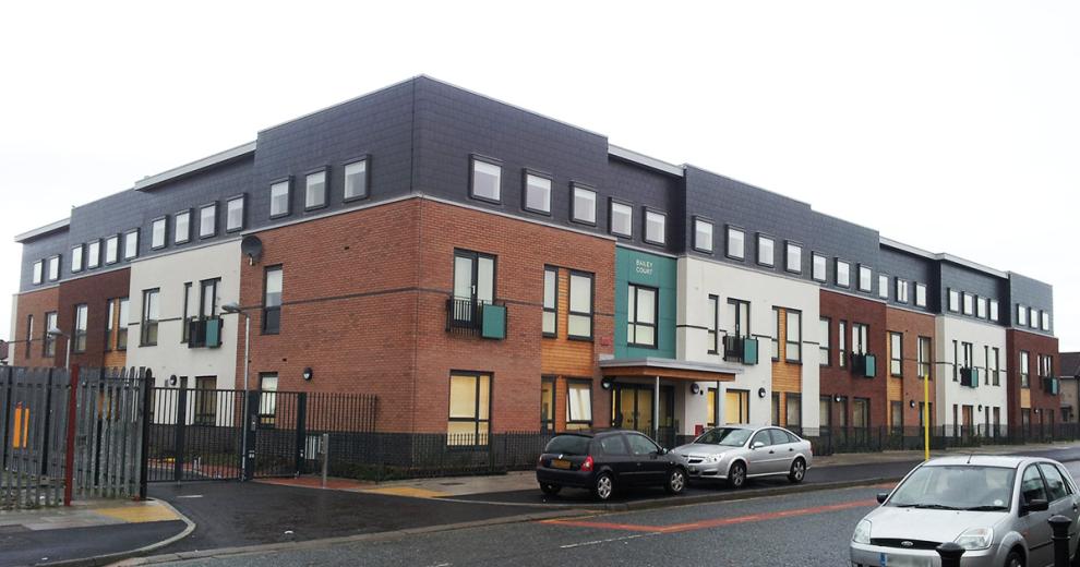 A grandiose, modern building, using colour and building materials to section off each part of the property. The entrance is on street level with no step access as well as gated side entry.