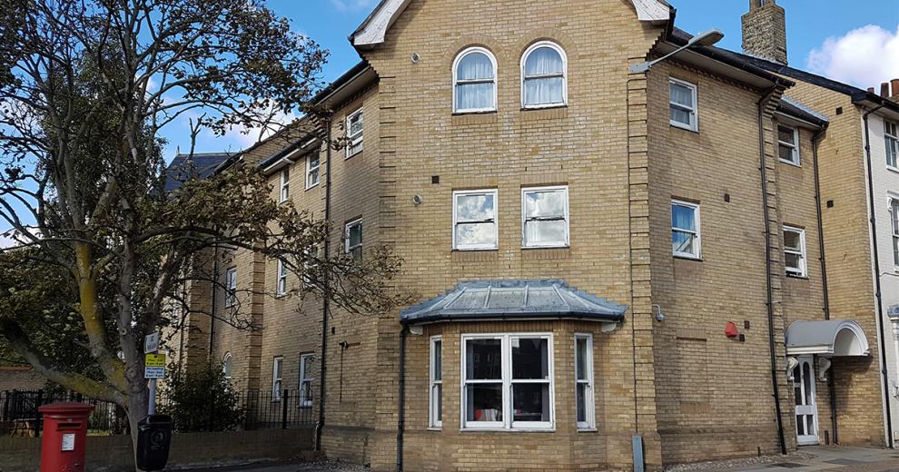 Corner, three storey property with feature porch over the approach to the entrance of the building.