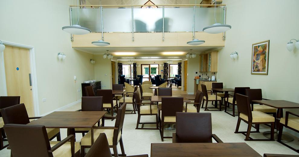 An open spaced area filled with a more formal dining room style seating area. Small mahogany squared dining room sets flow into a small kitchenette with tea making facilities.