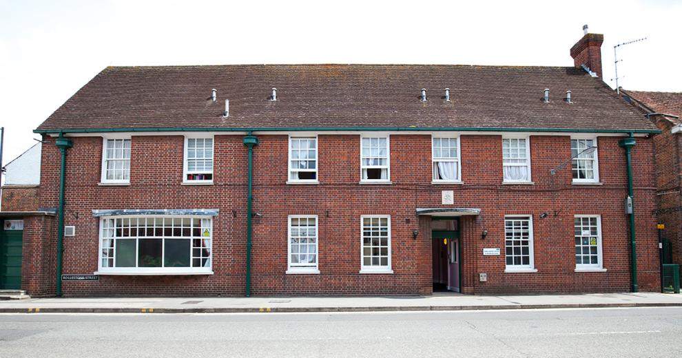 Long exterior classic style red bricked building.