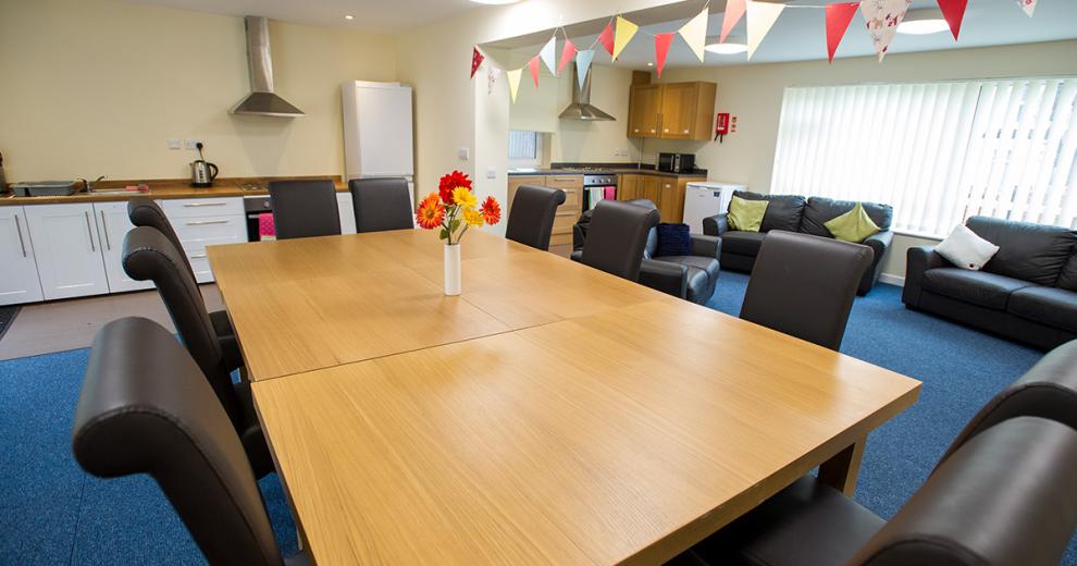 Enormous communal area, with two fully functional, modern kitchens. A dining seated space to comfortably hold ten people, leading into an area with a more relaxed seating option.
