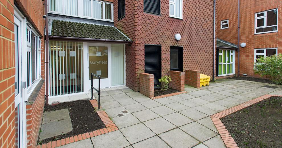 No step access into the entrance of Maryfield. Surrounds by a well-kept squared paving stone, with a red bricked boarder around the planting areas to link back to the building.