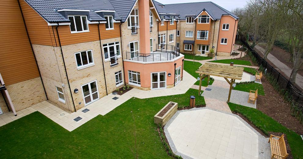 The simplistic garden area has paved stone walkways around the perimeter of the property. With the minimal grassed areas the space is home to three benched seating areas.