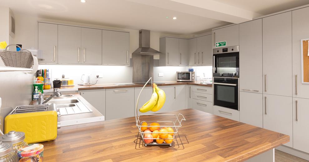 Beautiful, crisp, clean, communal kitchen. The spacious kitchen consists of modern appliances, with two ovens, an electric hob, large stainless steel microwave as well as introducing pops of colour in to the remaining appliances. There is an abundance of floor to ceiling storage options available.