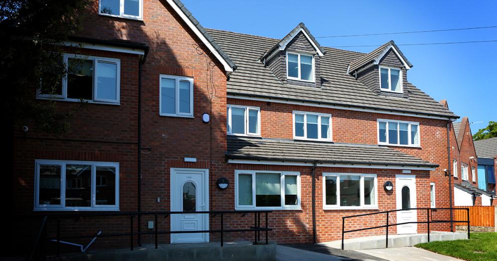 New build, three storey properties with ramp and wheelchair access. Featuring security lighting by the PVC front doors and a small grassy front garden.