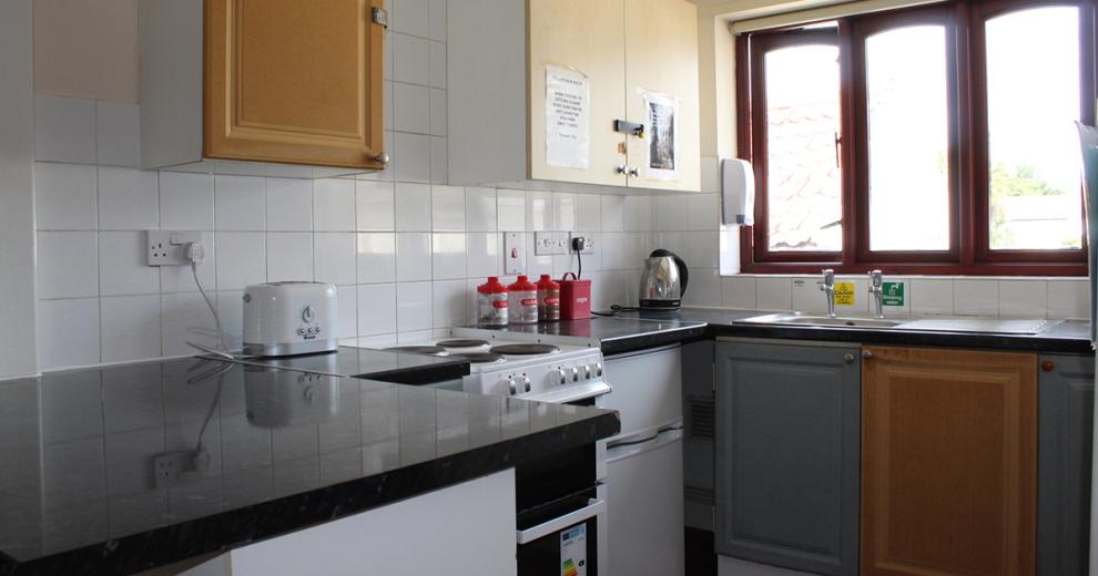 Clean and tidy modest kitchen, with all necessities present for use.