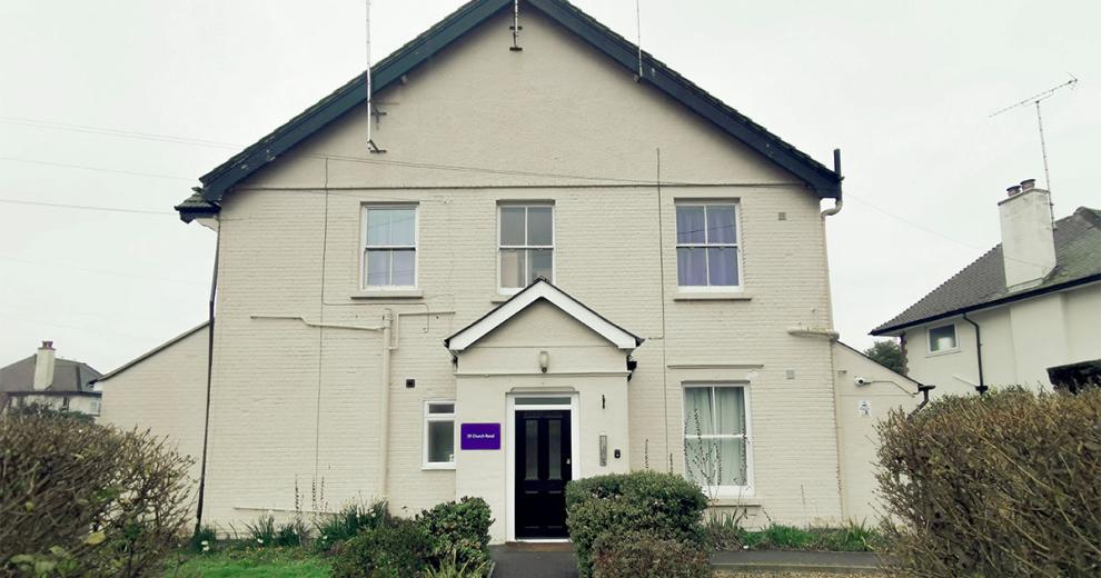 A large semi detached white rendered supported living property