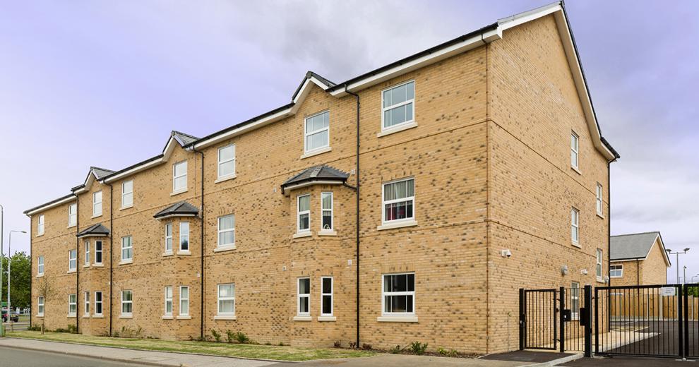 Yellow brick-built property with enhanced security features for residents.