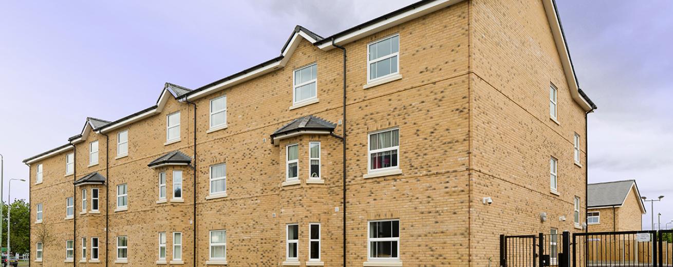Yellow brick-built property with enhanced security features for residents.