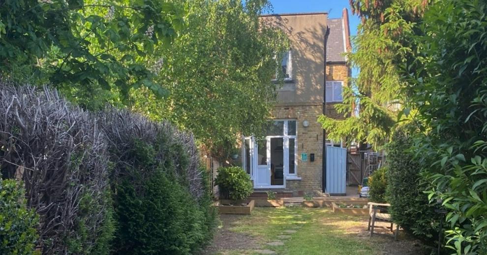 Good sized grassed garden, with luscious trees and shrubbery. Wooden gate granting access to the side of the home. Patio door entry to the main house.