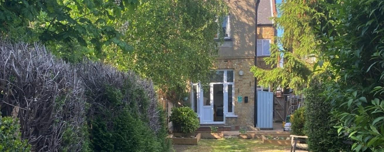 Good sized grassed garden, with luscious trees and shrubbery. Wooden gate granting access to the side of the home. Patio door entry to the main house.