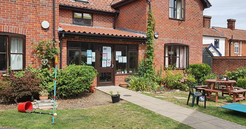A statement brick-built residence, with different elevation levels and clay roof tiles. With an inviting front garden, consisting of seating area and homely plants.
