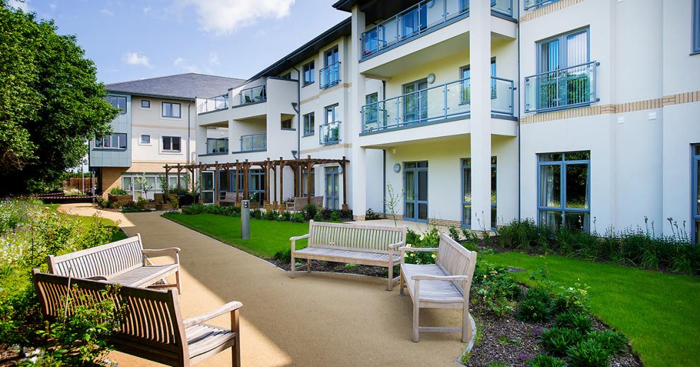 The well-maintained gardens offer a peaceful outdoor escape. The addition of semi-circle bulges to the walkways to allow for a communal seating area.