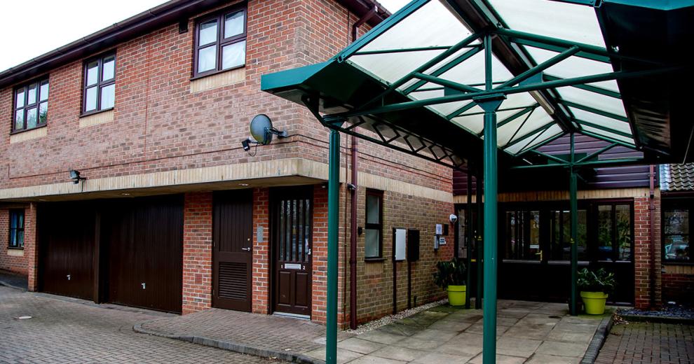 Large brick facility with dropped curbed access points and stepless entry. Providing onsite parking and twelve one-bedroom flats at Hilltop House.