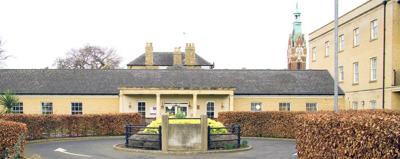 The entrance to the retirement community is accessed by a one way circular roundabout. The period designed stone built building is the main feature with the covered stone built porch with chunky columns supporting the roof. The rest of the building is built with soft coloured yellow bricks and long rectangular windows.
