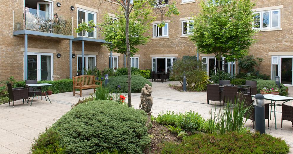 The patioed courtyard area has beautiful mix of open air seating and nature. Placed amongst the paving are areas od luscious shrubbery and mature planted trees. There is a mixture of seating option from wicker chairs and metal framed tables to wooden benches.