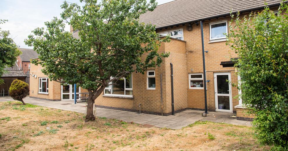 Spacious grassed outdoor area, trees and large shrubbery have been planted on the edge of the grassed and just before the slabbed walkway around the property to give a bit of privacy from the building.