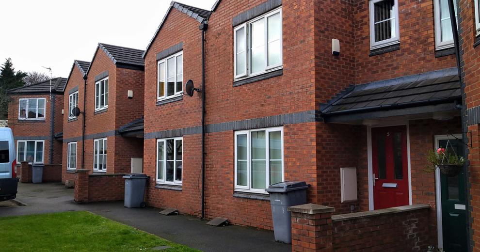 Beautiful contemporary buildings with white window frames with the multitoned red bricked exterior.