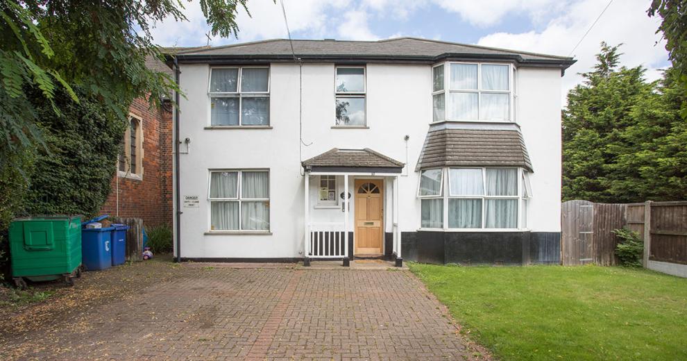 Grandiose white rendered detached home, with elongated driveway and grassed perimeter.