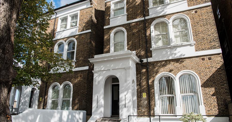 Beautiful, period property featuring multiple arched windows, with a statement porch entry to the care service.