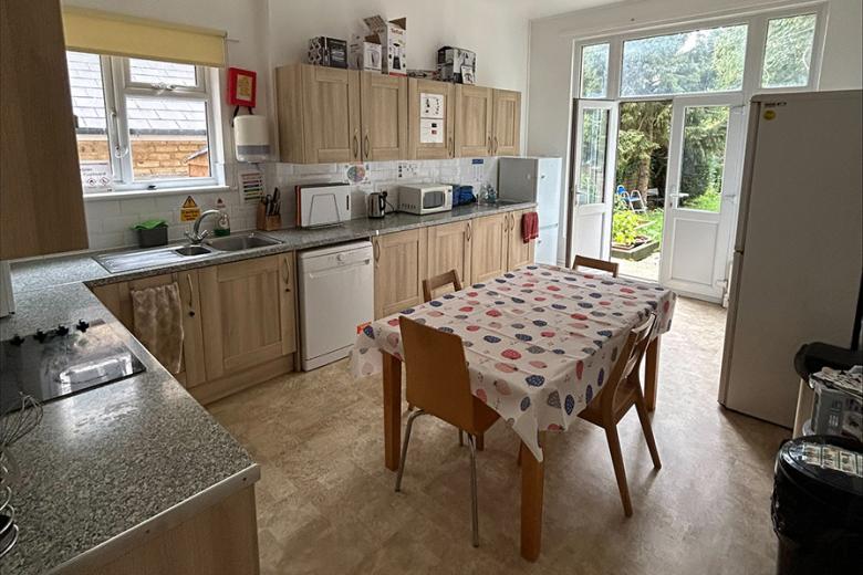 Light wooden kitchen design, complementing white subway tiles and an array of kitchen appliances. With access to the communal garden.