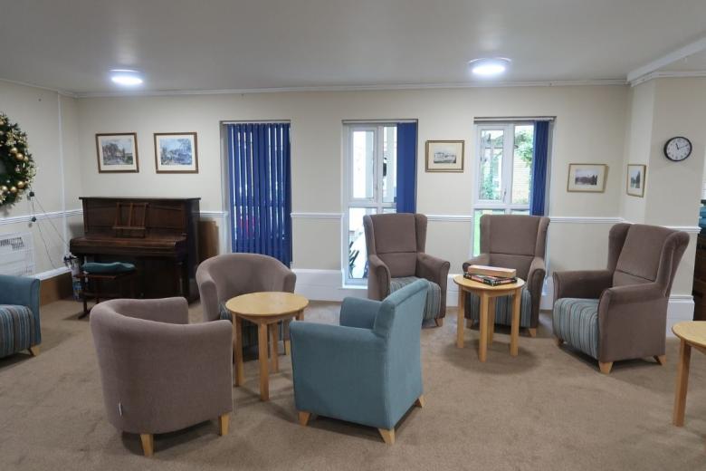 Communal lounge with comfortable seating, tables and piano