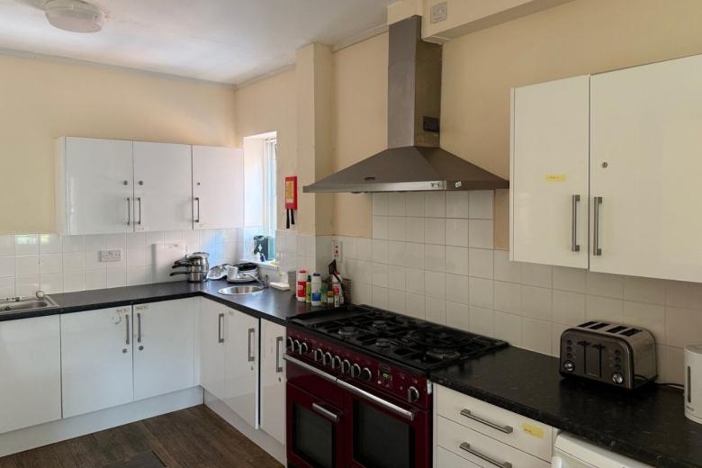 Shared kitchen with modern appliances, ample storage and cooking facilities at Sandwood House.